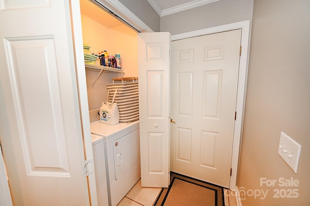 clothes washing area with separate washer and dryer, light tile patterned floors, and ornamental molding