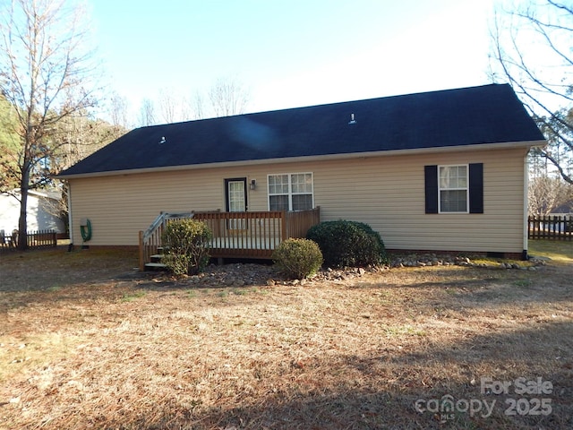 rear view of house with a wooden deck