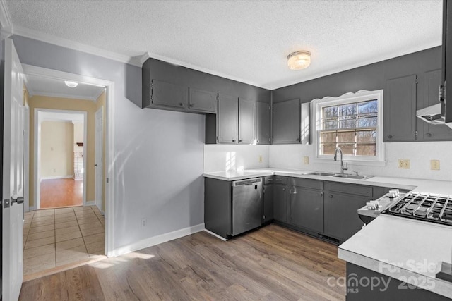 kitchen with dishwasher, a textured ceiling, hardwood / wood-style flooring, and sink