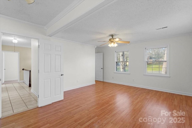 spare room with crown molding, ceiling fan, light hardwood / wood-style floors, and a textured ceiling