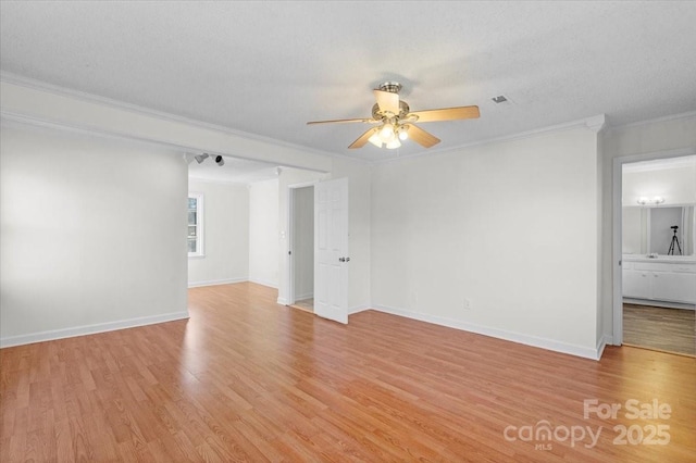 empty room featuring crown molding, light hardwood / wood-style flooring, ceiling fan, and a textured ceiling