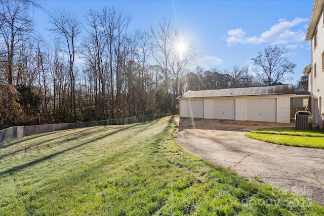 view of yard featuring an outbuilding, a garage, and cooling unit