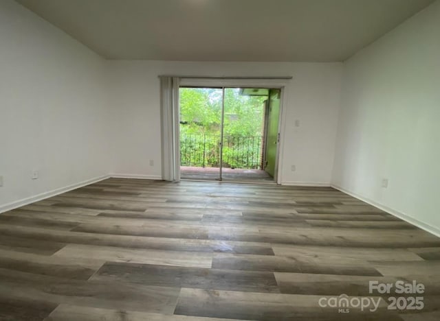 unfurnished room with wood-type flooring