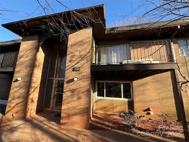 view of side of property with a balcony