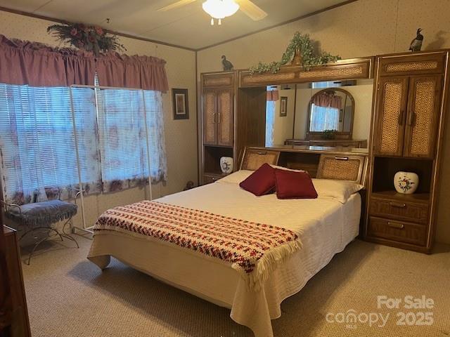 carpeted bedroom with ceiling fan