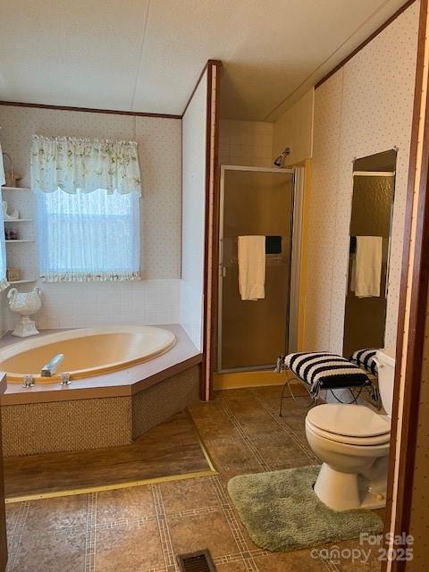 bathroom featuring ornamental molding, independent shower and bath, and toilet