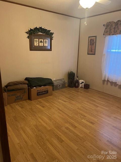 interior space with hardwood / wood-style floors and ceiling fan