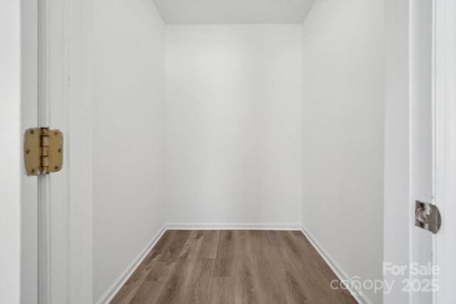 interior space featuring wood finished floors and baseboards