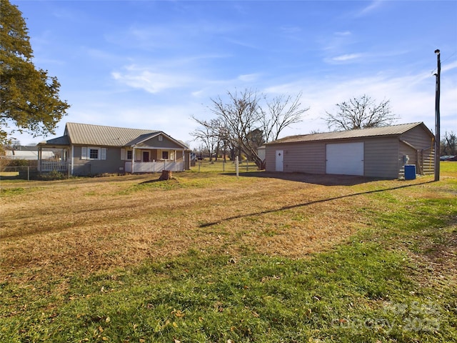 view of yard with a garage and an outdoor structure