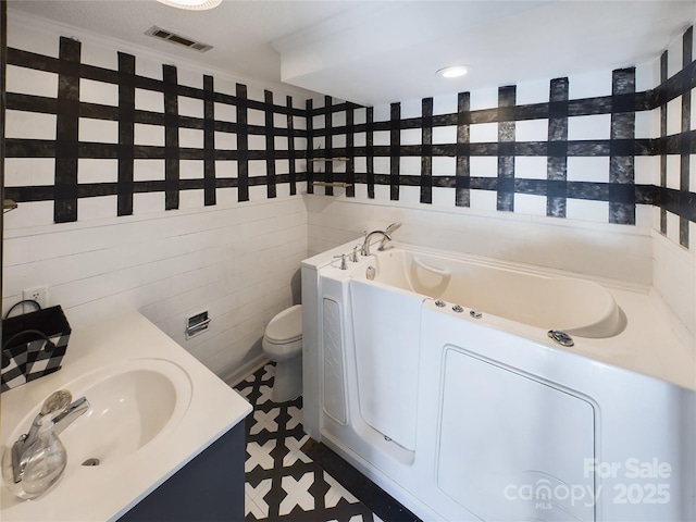 bathroom with crown molding, sink, a bath, tile walls, and toilet