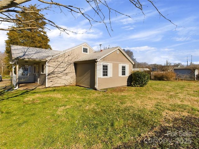 back of property featuring a lawn