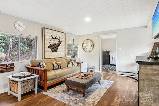 living room featuring hardwood / wood-style floors and a baseboard heating unit