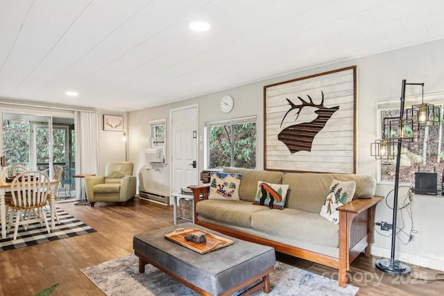 living room featuring hardwood / wood-style flooring and a baseboard heating unit