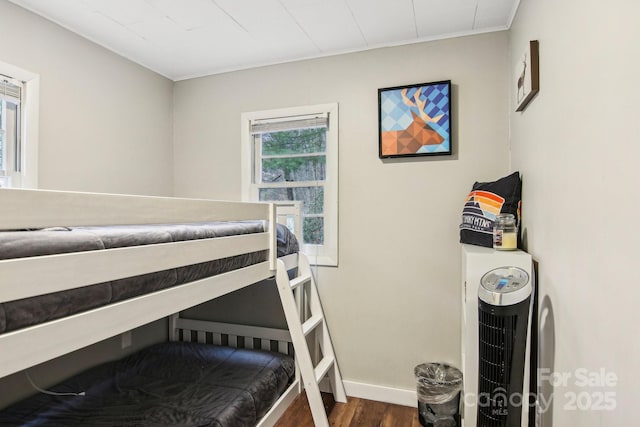 bedroom with dark hardwood / wood-style flooring