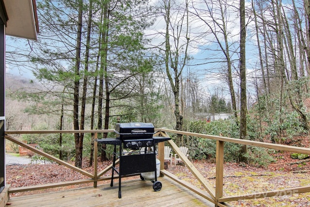 wooden terrace with a grill