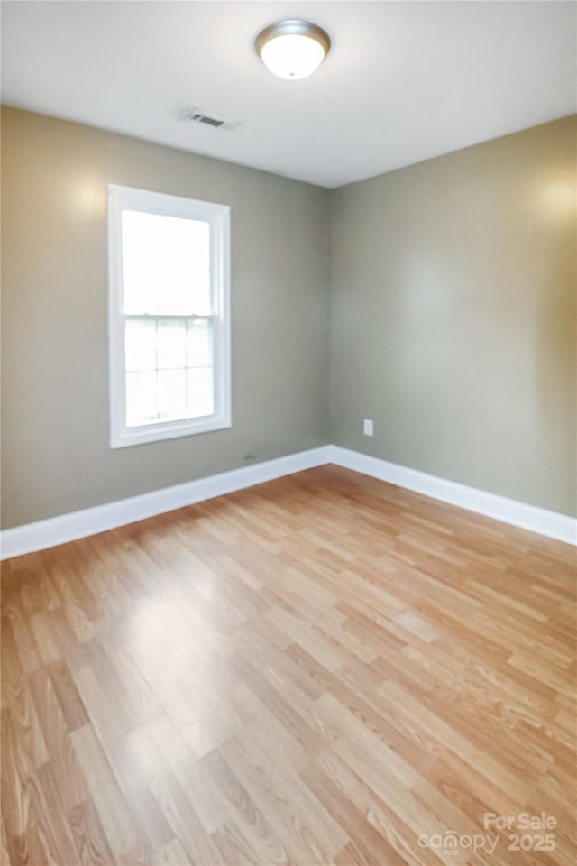 unfurnished room featuring light hardwood / wood-style flooring