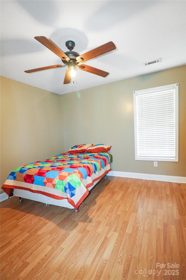 bedroom featuring ceiling fan and light hardwood / wood-style floors