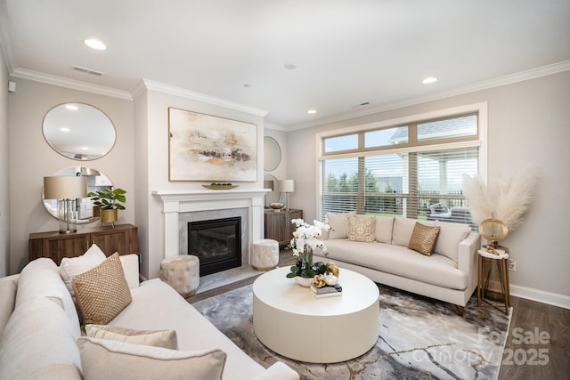 living room featuring dark hardwood / wood-style floors, ornamental molding, and a fireplace