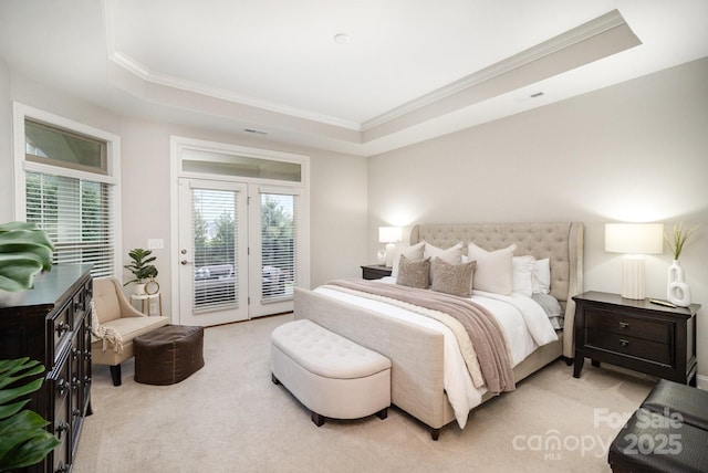 carpeted bedroom with access to exterior, a raised ceiling, and ornamental molding