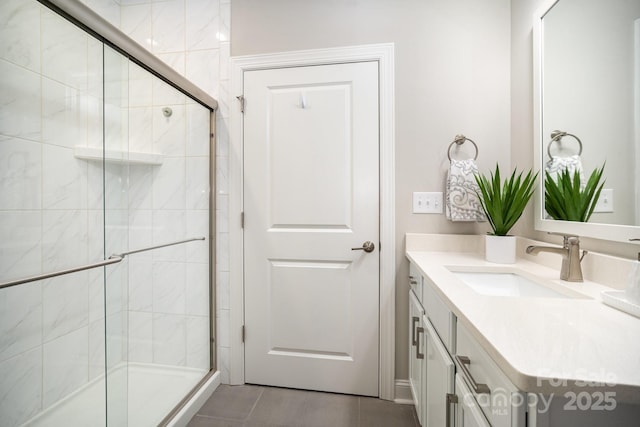 bathroom featuring tile patterned floors, vanity, and walk in shower