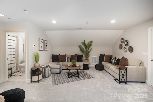 carpeted living room with lofted ceiling