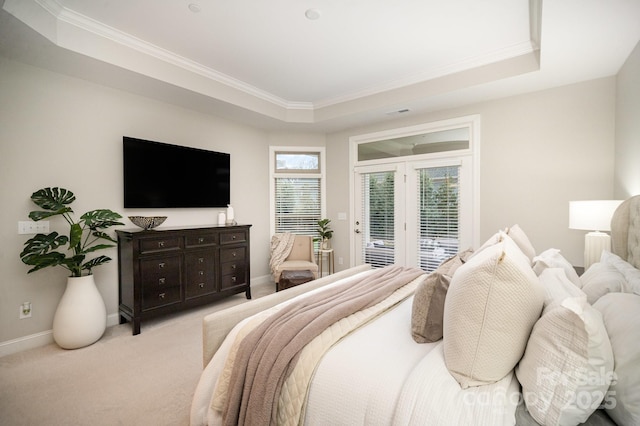 bedroom featuring a tray ceiling, light carpet, crown molding, and access to outside