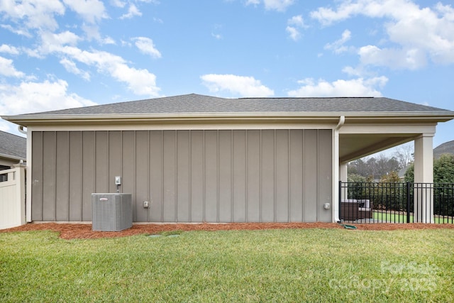 view of home's exterior with a lawn and central AC