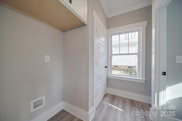 interior space featuring light wood-type flooring and crown molding