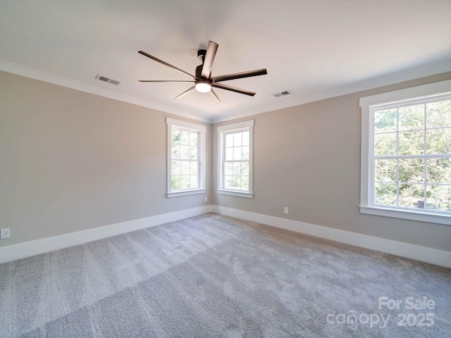 carpeted empty room with ceiling fan and ornamental molding