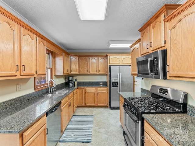 kitchen featuring dark stone countertops, sink, stainless steel appliances, and a textured ceiling