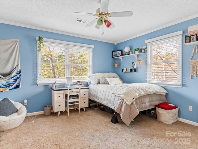 carpeted bedroom with a textured ceiling, ceiling fan, and crown molding