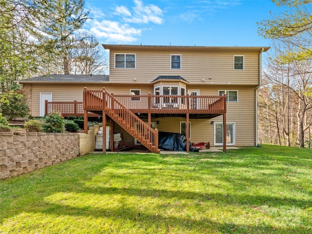 back of house with a lawn and a wooden deck