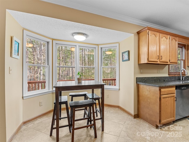 kitchen featuring a wealth of natural light, dishwasher, and light tile patterned floors