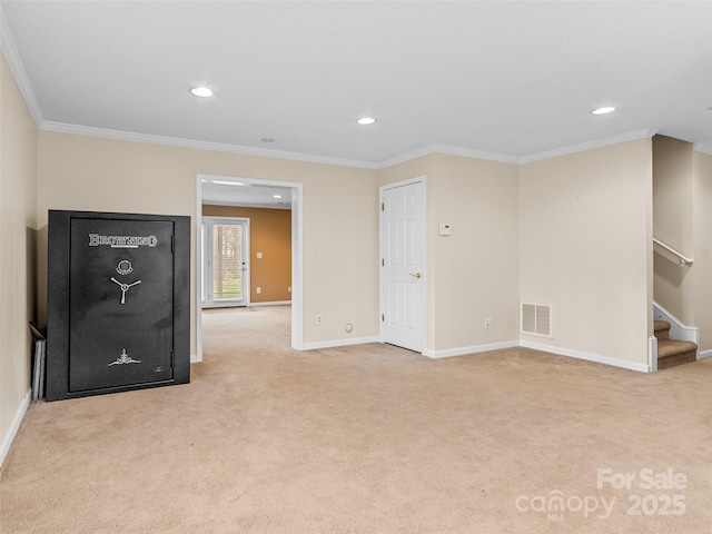 carpeted spare room featuring crown molding