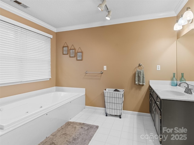 bathroom featuring tile patterned flooring, a bath, vanity, and a textured ceiling