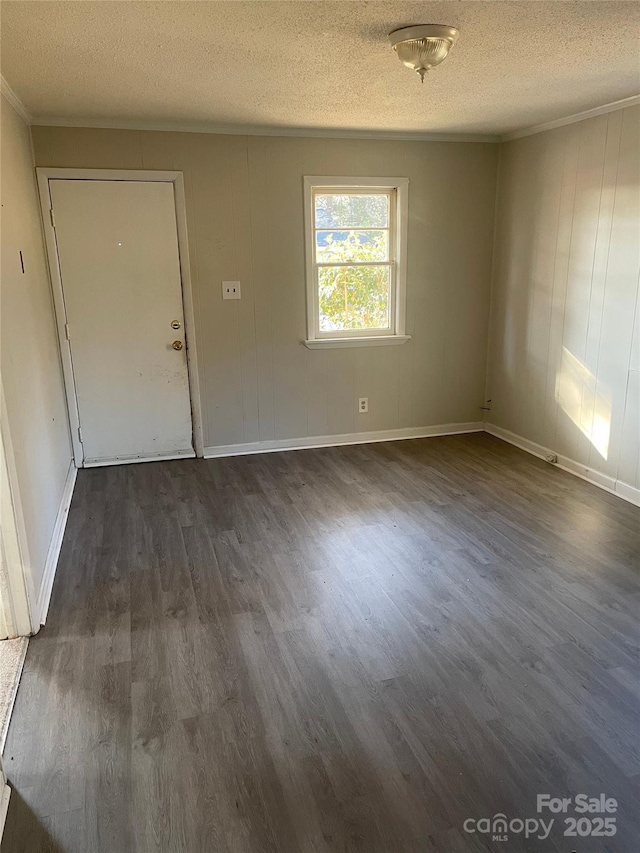 foyer entrance featuring a textured ceiling and dark wood-type flooring