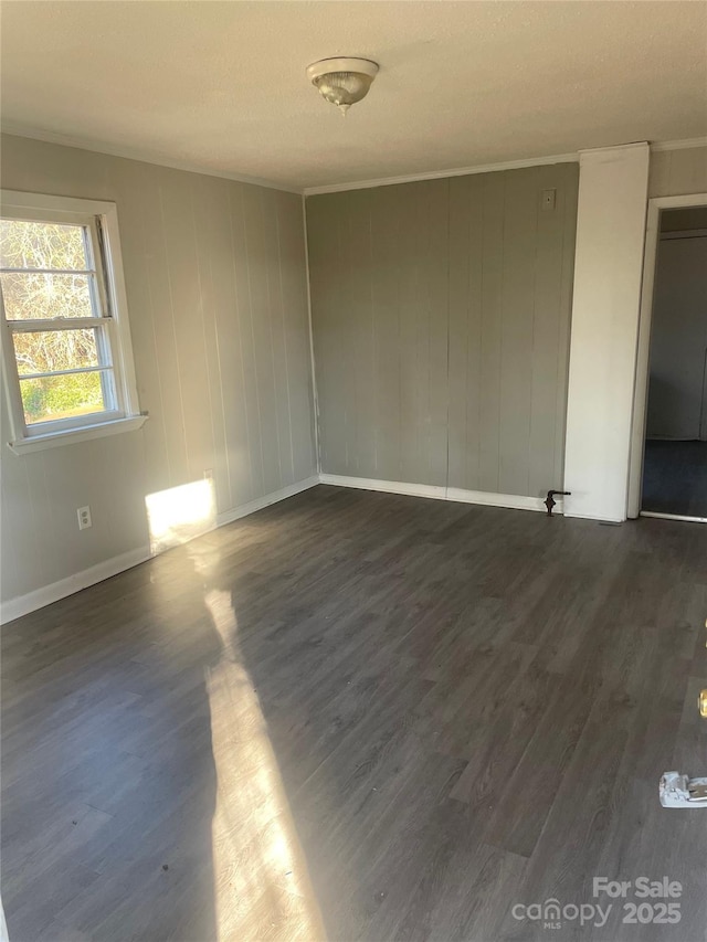 spare room featuring dark wood-type flooring