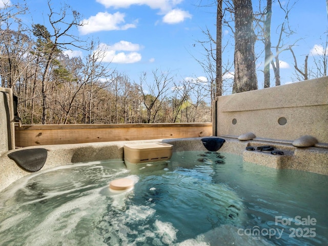 view of pool with a hot tub