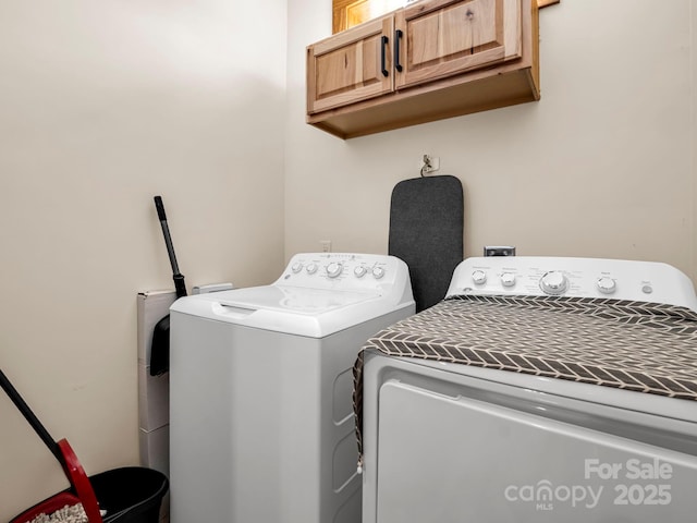 washroom with cabinets and separate washer and dryer