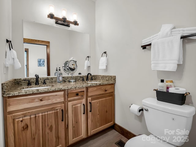 bathroom featuring hardwood / wood-style floors, vanity, and toilet