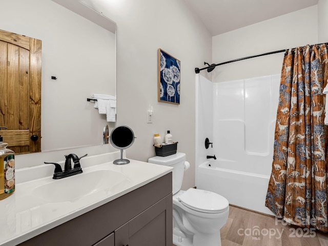 full bathroom with hardwood / wood-style floors, vanity, toilet, and shower / tub combo with curtain