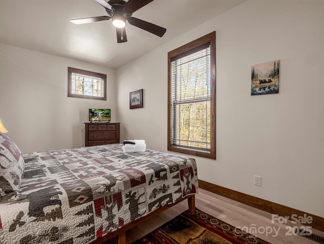 bedroom with hardwood / wood-style floors and ceiling fan