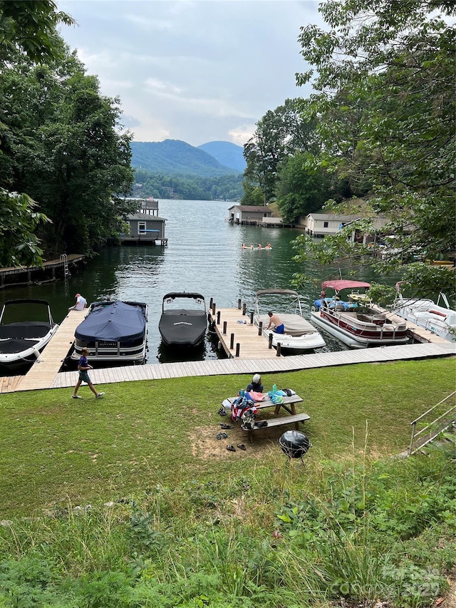 view of water feature with a mountain view and a boat dock