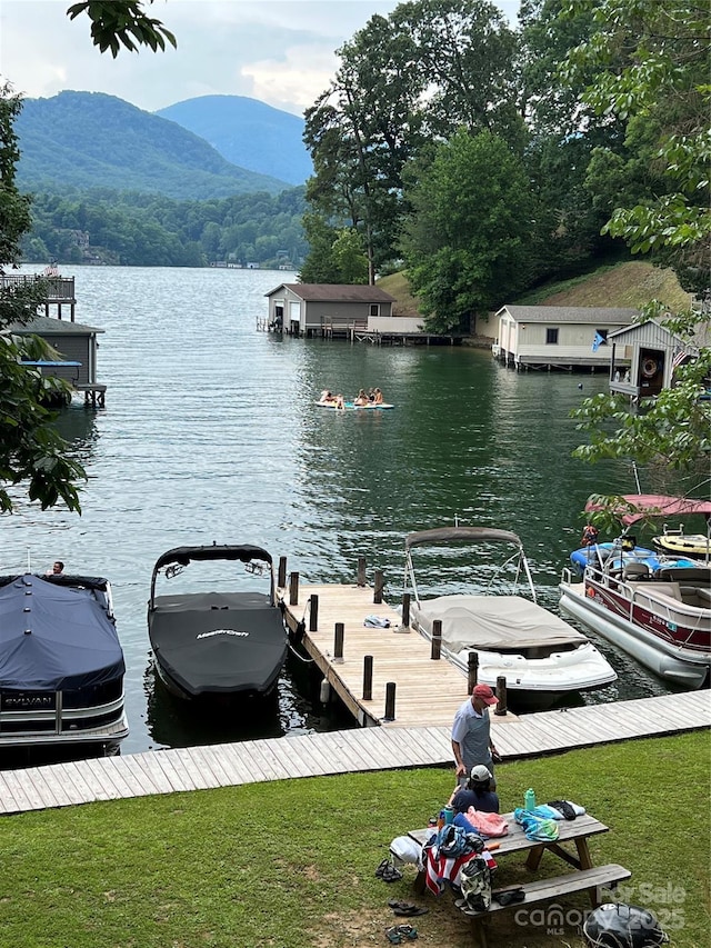 view of dock with a water and mountain view