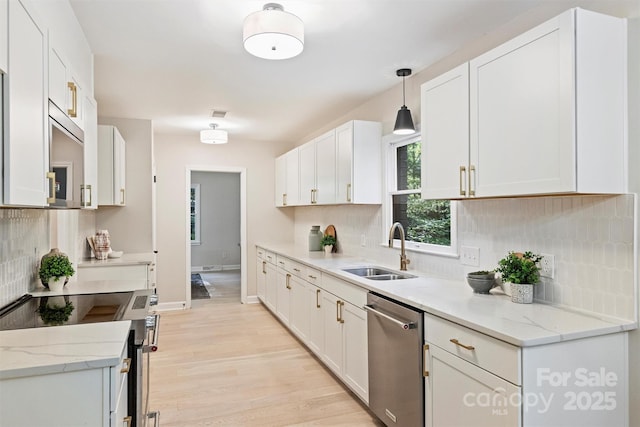 kitchen with white cabinetry, dishwasher, decorative light fixtures, and sink