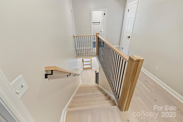 stairway with wood-type flooring