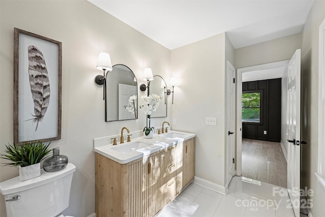 bathroom featuring tile patterned flooring, vanity, and toilet