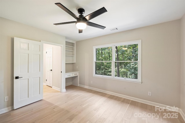 unfurnished bedroom with ceiling fan and light hardwood / wood-style flooring