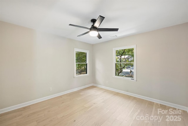 spare room featuring light hardwood / wood-style flooring and ceiling fan