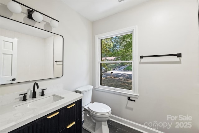 bathroom with tile patterned floors, vanity, and toilet